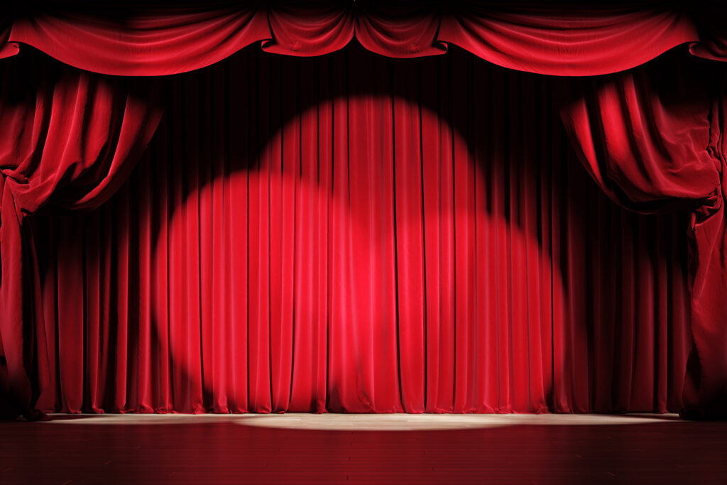 Telón rojo del escenario de un teatro.